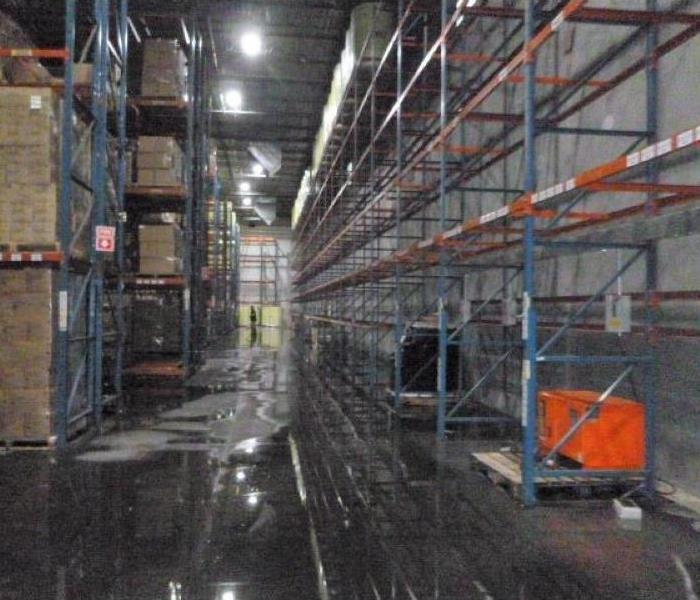 Shows water, flood, in a warehouse