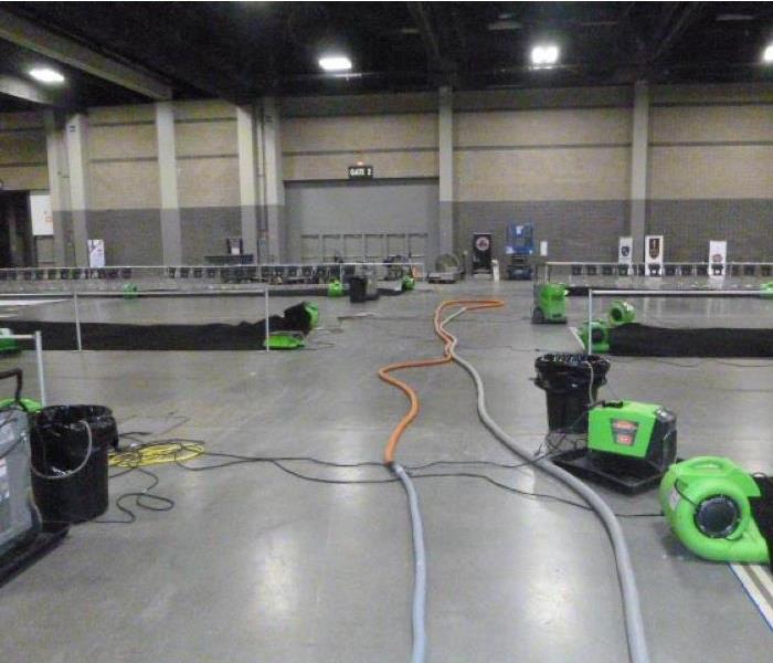 Bright green SERVPRO drying equipment in convention center