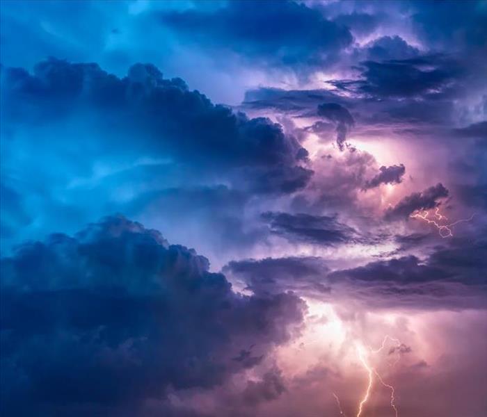 Ominous purple and blue storm clouds with lightning