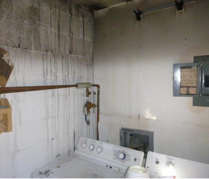 Image of burned wall and soot on laundry appliances